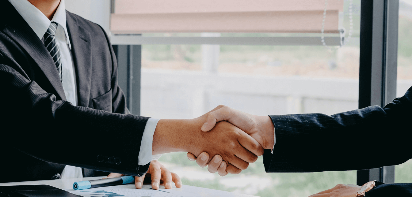 Two people shaking hands to seal a deal