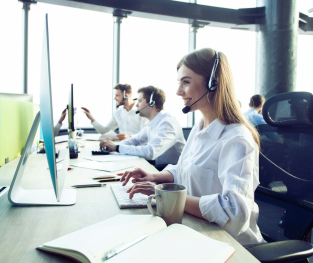 People in front of screens wearing headphones