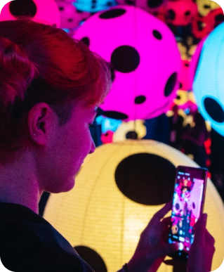 woman taking photos at an art exhibition