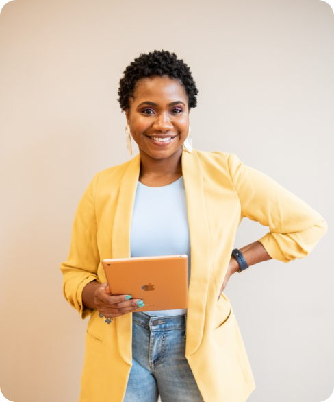 Woman smiling while holding a laptop