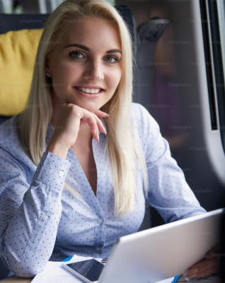 Woman smiling while holding a laptop