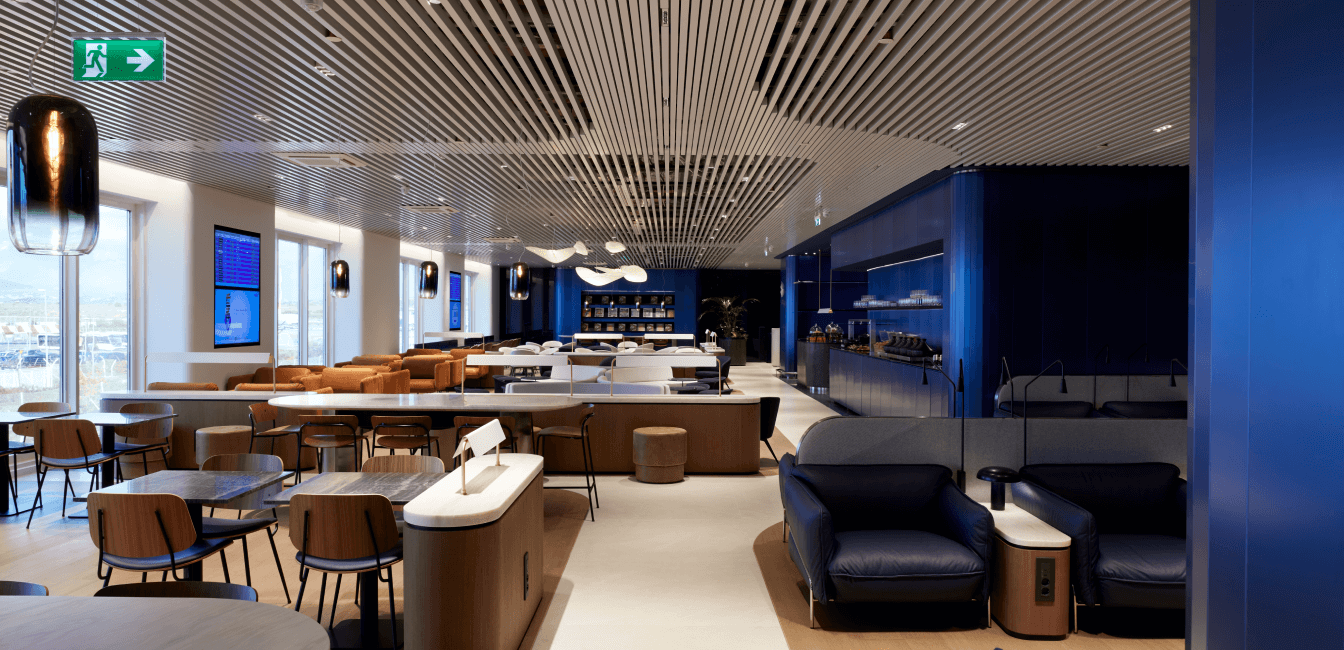 Business lounge with tables, chairs, bar and large windows