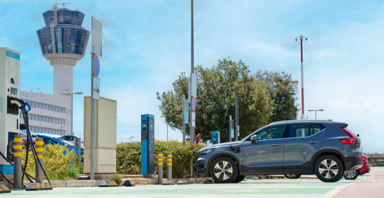 electric cars in front of a charger athens international airport